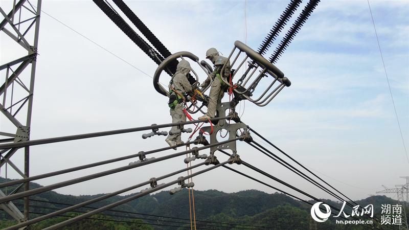 ±800千伏祁韶线4374号杆塔上电力员工正在作业。刘辉军摄