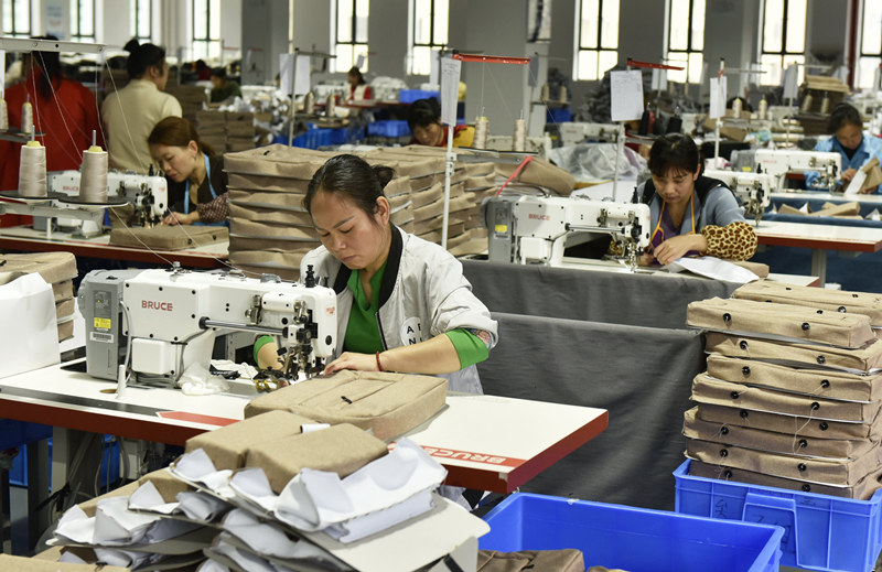 皮具企業工人在生產線上趕制出口訂單。楊雄春攝