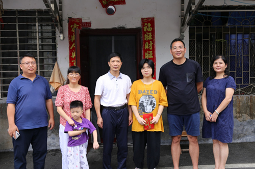 郴州市残联党组书记、理事长李典龙（左三）与廖槟一家合影。受访者供图