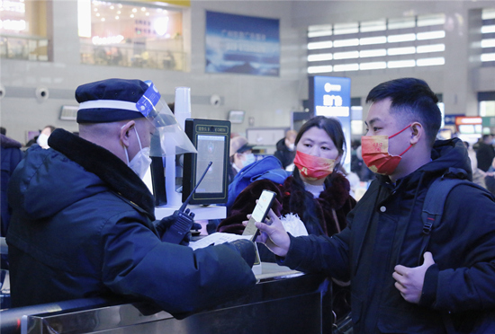 车站工作人员在查验旅客电子车票。受访单位供图