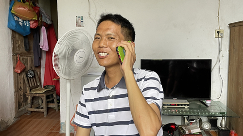 陈先生接到老同学的慰问电话，露出笑容。受访单位供图