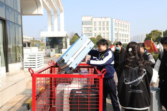 學生將行李放上無人叉車。受訪單位供圖