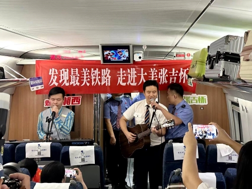 列車長與餐飲乘務員合作彈唱。曾愉捷攝