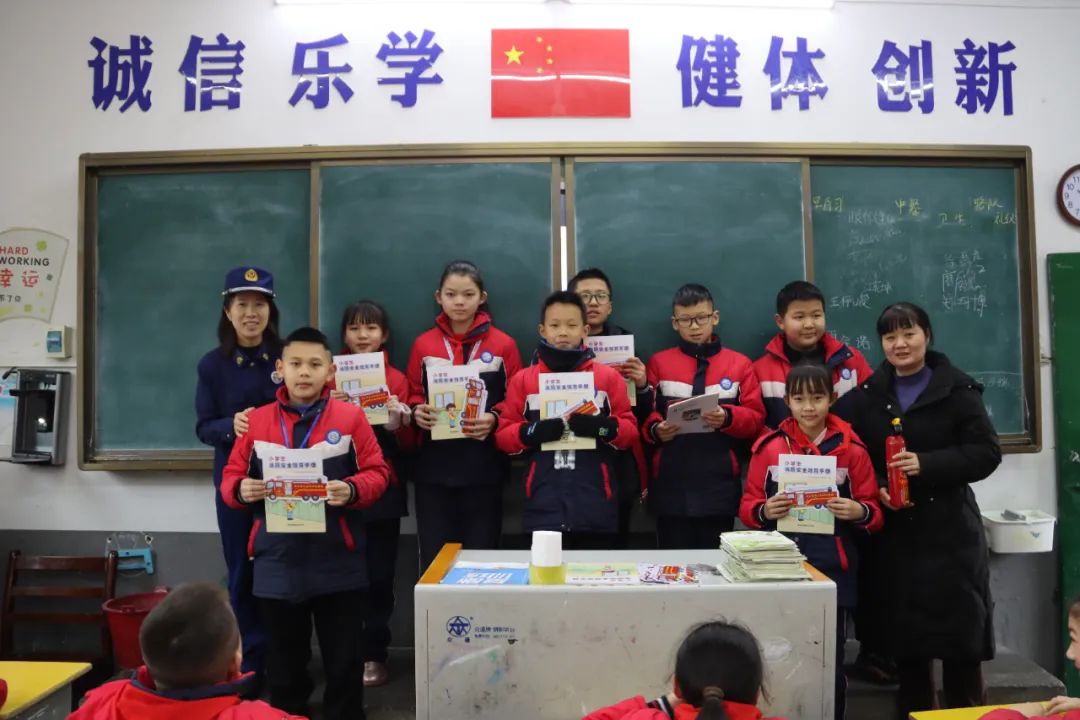 消防宣传员为小学生发放《小学生消防安全教育手册》（单位供图）