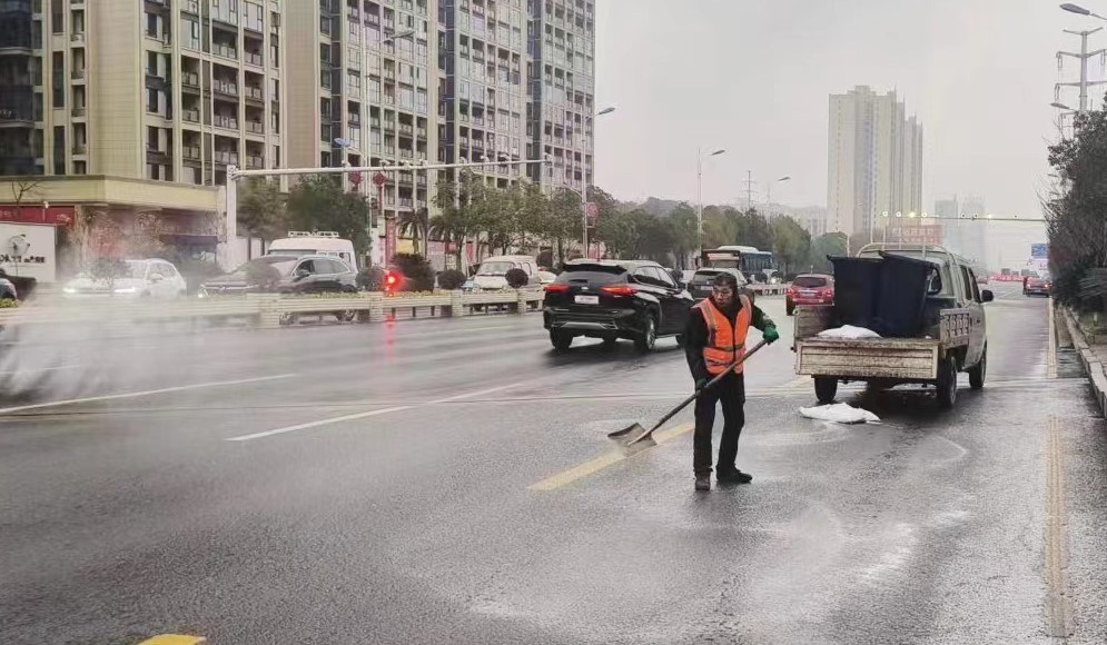 环卫工人在街上撒盐除冰(单位供图)