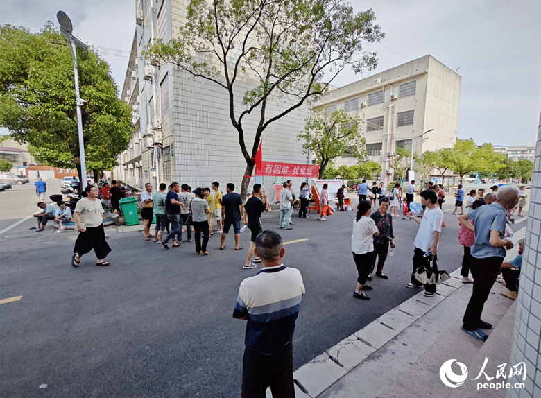 住宿区在进行消毒，安置群众在户外等候。人民网记者 刘宾摄