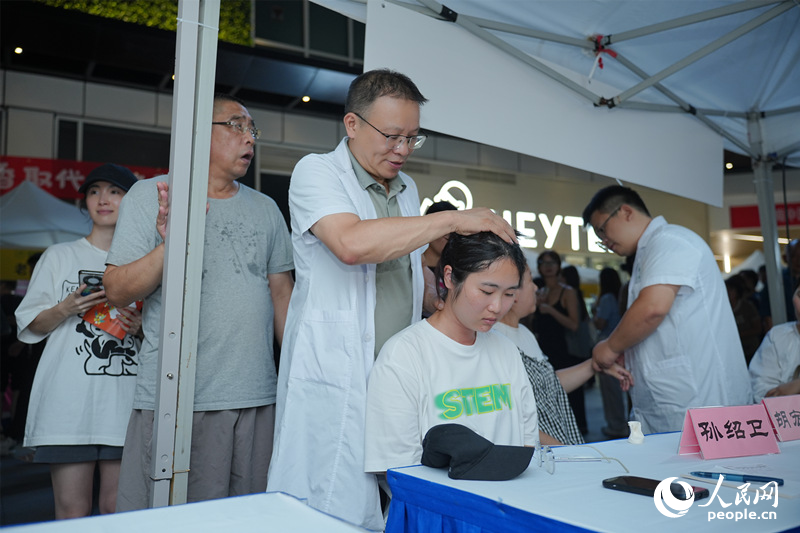 中医医生对市民进行脊柱检查。人民网记者 林洛頫摄