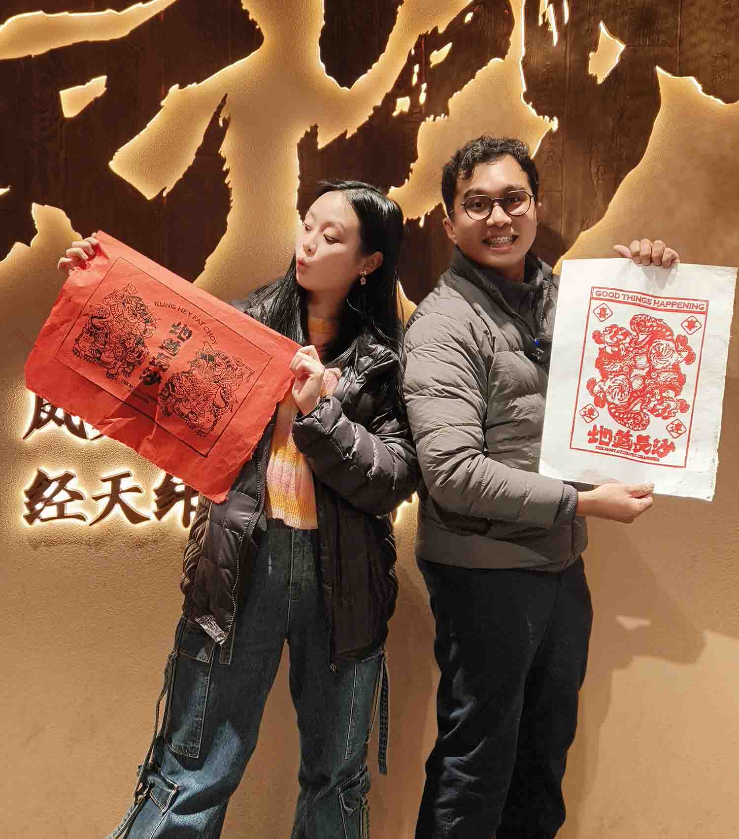 印尼博主吉哈迈德（男）和吉尼西亚（女）展示自己的非遗拓印作品。受访单位供图