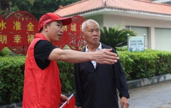 “全国最美志愿者”韦顺江开展文明劝导，为市民服务。罗江摄