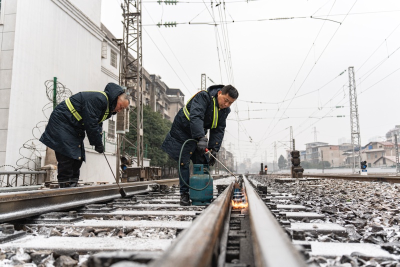 铁路工作人员对铁轨进行除雪。受访单位供图