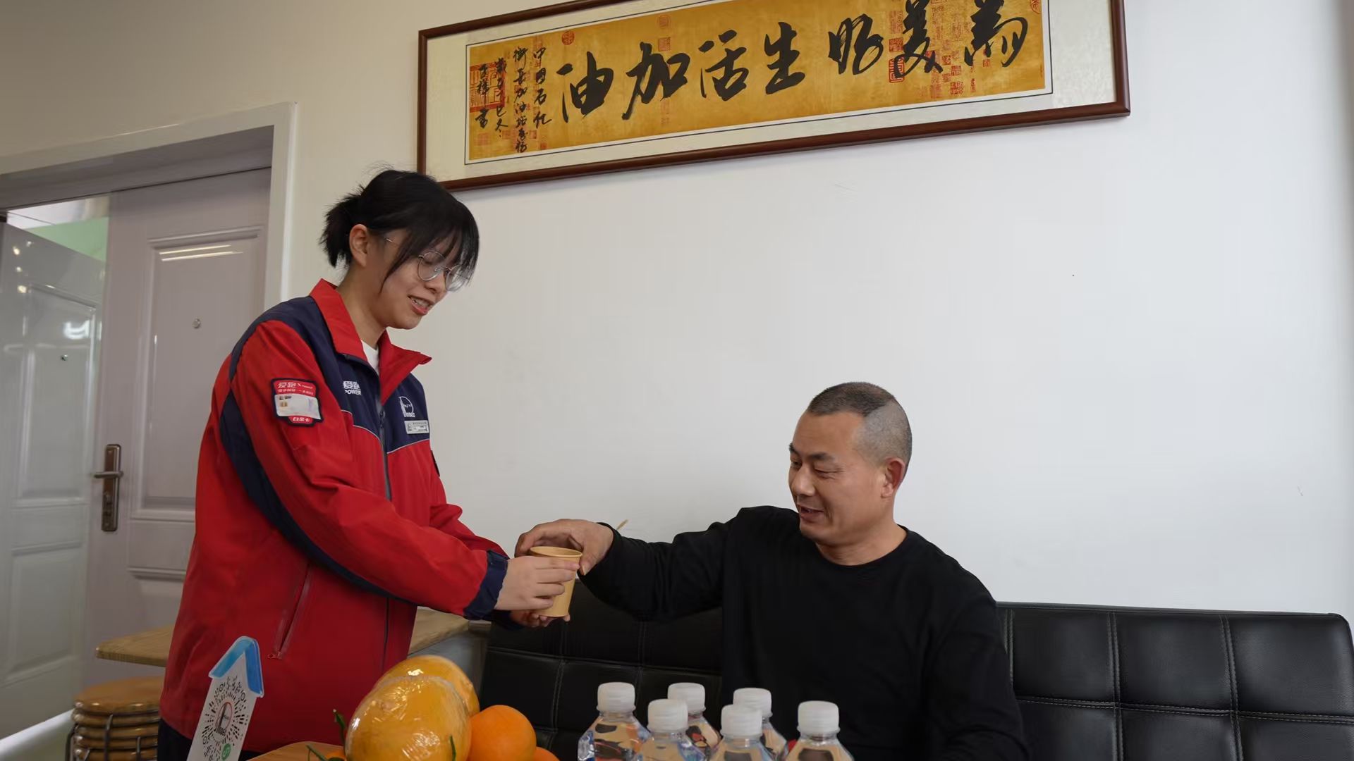 在衡岳加能站司機之家,加油員給休息的卡車司機遞上熱茶。雷欣雨攝