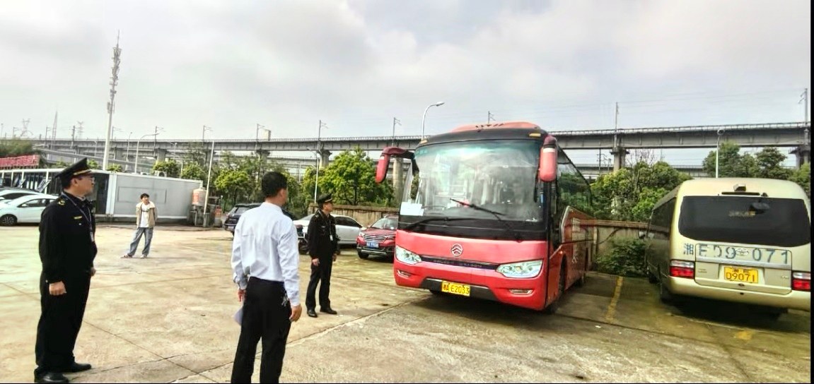 （图为跟岗执法人员查看客运车辆行车前安全例检）单位供图