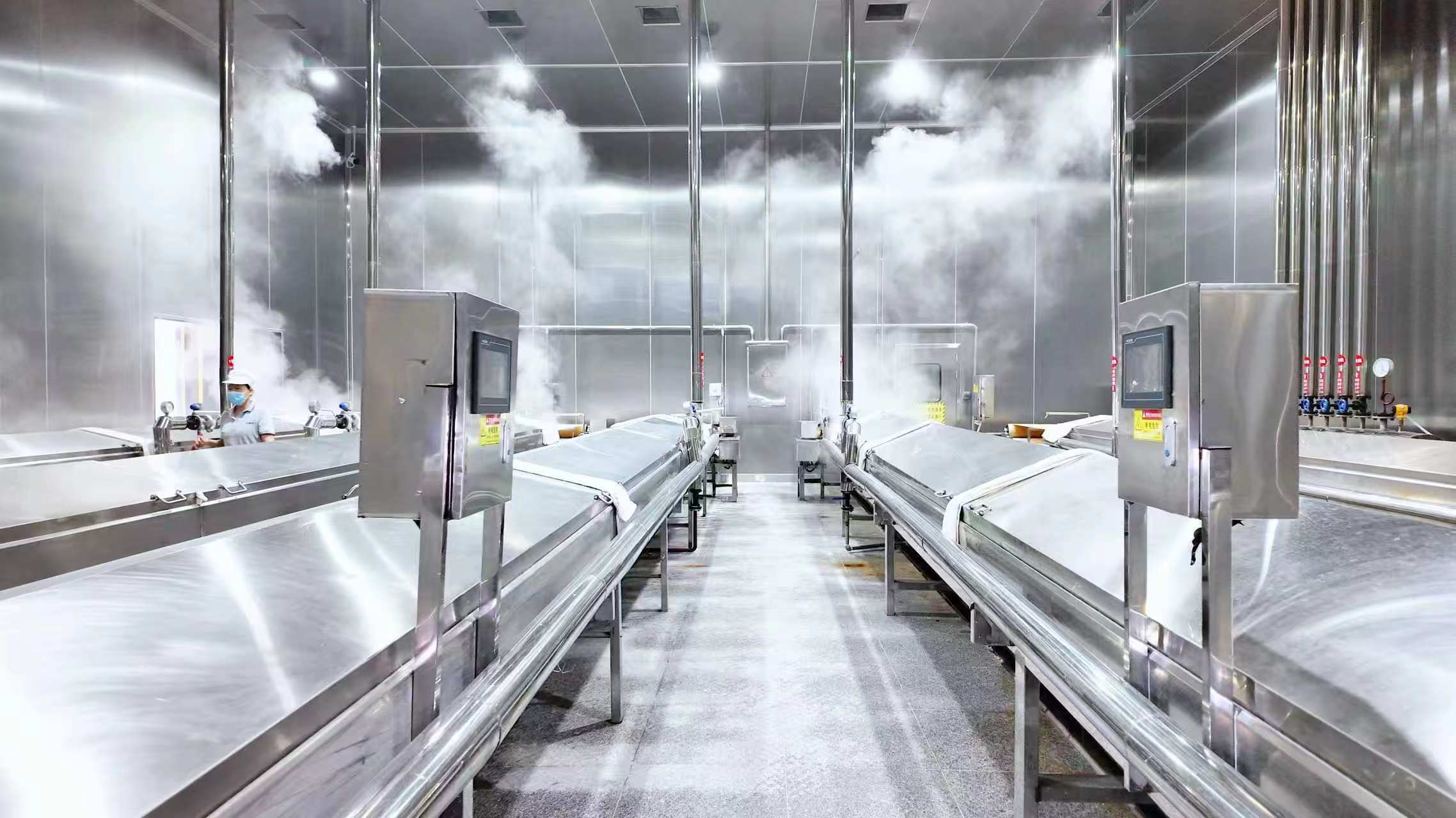 金风食品鲜湿米粉熟化车间，链条式蒸箱正在工作中。单位供图