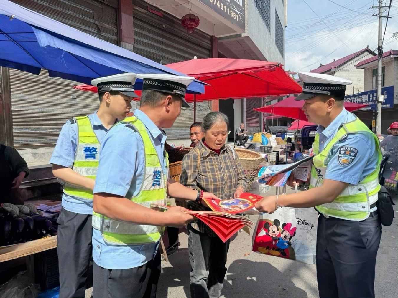 民輔警在麻栗場鎮集市宣傳道路交通安全知識（單位供圖）