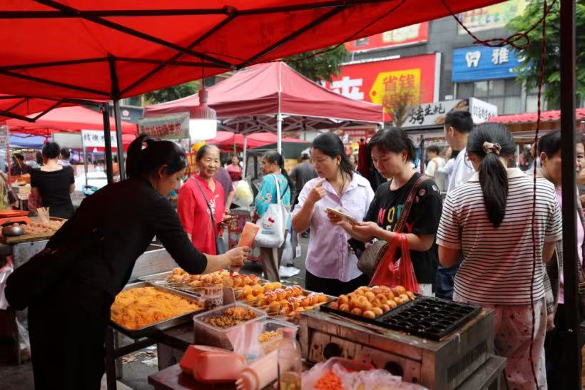 市民們正在挑選特色美食。陳學華攝