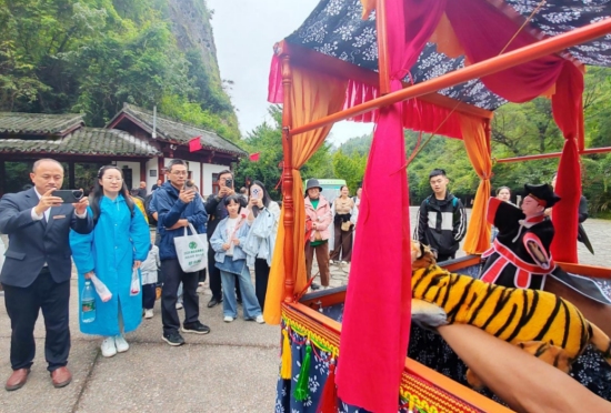 游客駐足欣賞國家級非遺邵陽布袋戲展演。鄢躍斌攝