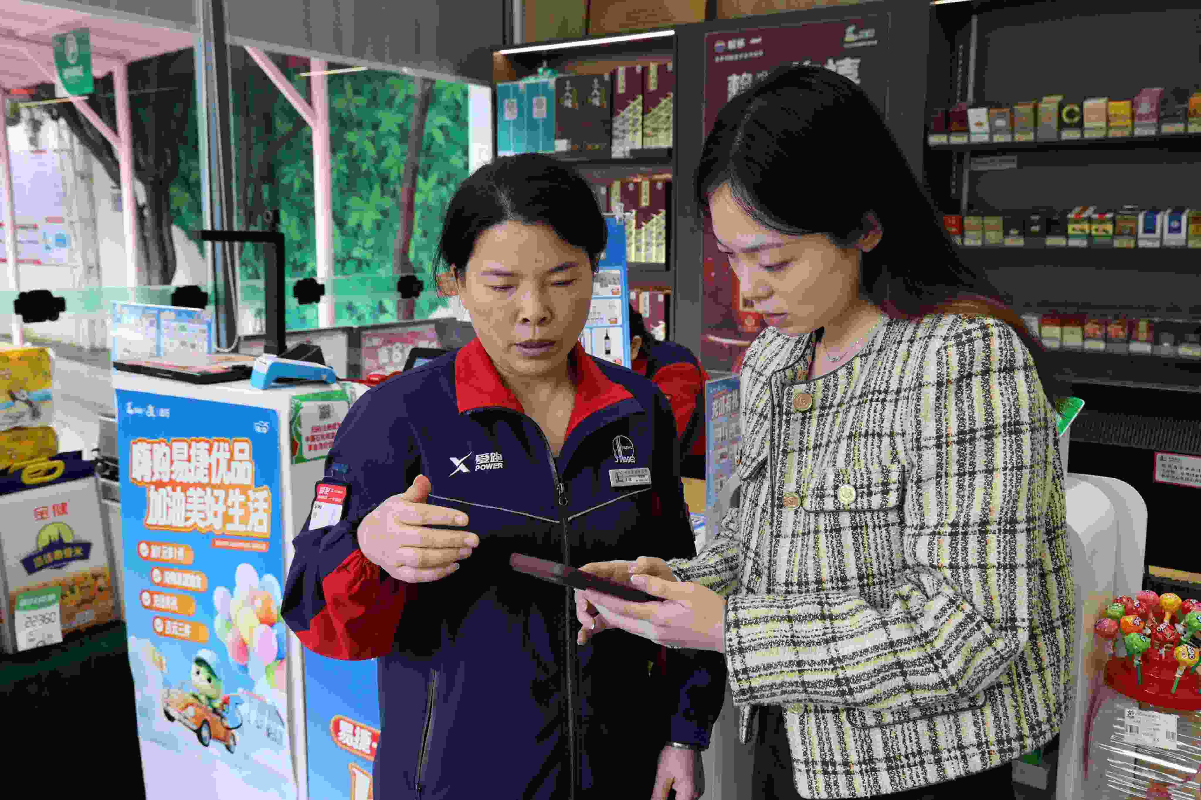 员工指导顾客在易捷加油app上办理“交易即开票”操作。单位供图